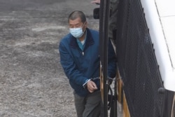 Jimmy Lai of Next Digital, which publishes the Apple Daily newspaper, is escorted by Correctional Services officers to prison, in Hong Kong, Dec. 3, 2020.