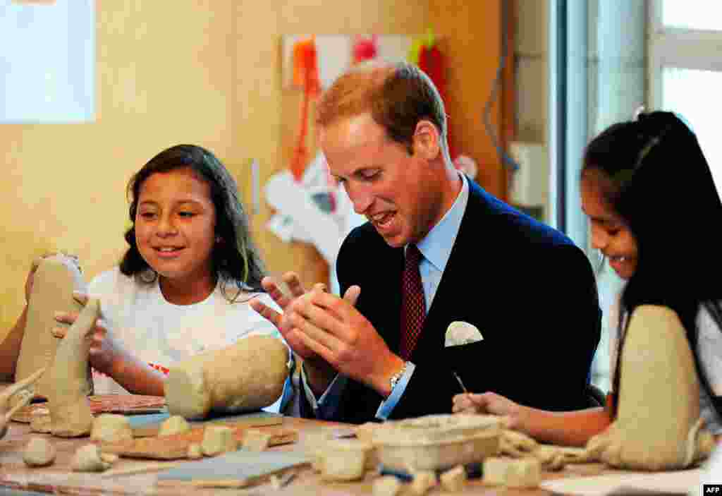 July 10: Britain's Prince William works with clay with students during a ceramics class at he Inner-City Arts campus in Los Angeles, California. REUTERS/Mike Nelson