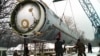Soldiers prepare to destroy a ballistic SS-19 missile in the yard of the largest former Soviet military rocket base in Vakulenchuk, Ukraine, December 24, 1997. 