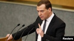 Russia's Prime Minister Dmitry Medvedev gestures during an address to the Lower House of Parliament in Moscow, April 17, 2013.