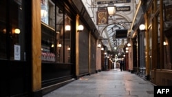 A picture taken on November 8, 2020 shows the deserted Passage des Panoramas, as France is on a second lockdown aimed at containing the spread of Covid-19 pandemic caused by the novel coronavirus. (Photo by JOEL SAGET / AFP)