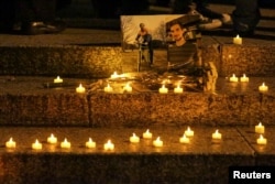 FILE - Candles are seen during a vigil for victims of the pickup truck attack at Foley Square in New York City, Nov. 1, 2017.