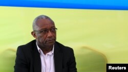 Kalisa Mbanda, Rwanda national electoral commission chairman, watches as votes are being counted at Amahoro polling station soon after polling closed in Rwanda's capital Kigali, Dec. 18, 2015. 