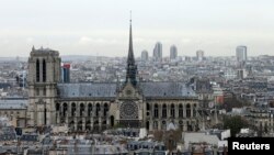 FILE - A city view shows the Notre Dame Cathedral, March 30, 2016, as part of the skyline in Paris, France. The April 15, 2019 fire toppled the Gothic landmark's spire and damaged the roof.