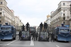 A police barricade with two water cannons is set blocking a street during an opposition rally to protest the official presidential election results in Minsk, Belarus, Sept. 6, 2020.