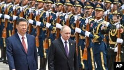 FILE - Chinese President Xi Jinping, left, and Russian President Vladimir Putin review the honor guard during a welcome ceremony in Beijing, May 16, 2024. Moscow and Beijing have long touted the strength of their relationship. (Sputnik via AP)