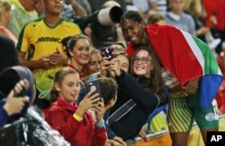 South Africa's Caster Semenya takes a selfie with fans after winning gold in the women's 1500m final at Carrara Stadium during the Commonwealth Games on the Gold Coast, Australia, April 10, 2018.
