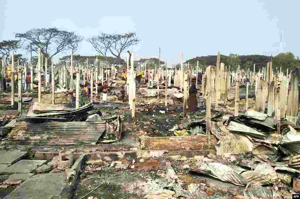 Rohingya refugees search for their belongings after a fire broke out at Nayapara refugee camp in Teknaf, Bangladesh.