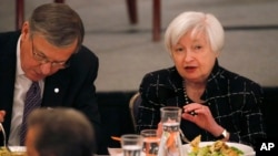 Federal Reserve Chair Janet Yellen, right, talks with Christopher B. Begy, CEO of BMO Financial Group, before her address to the Executives' Club of Chicago, March 3, 2017, in Chicago.