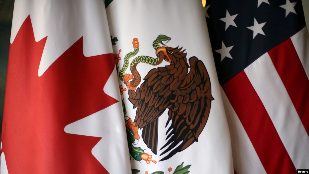 FILE - From left, the flags of Canada, Mexico and the United States are pictured at NAFTA talks in Mexico City, Nov. 19, 2017. 