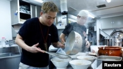 Ramen shop Menya Taisei's owner Taisei Hikage cooks ramen at his shop in Tokyo, Japan, October 22, 2024