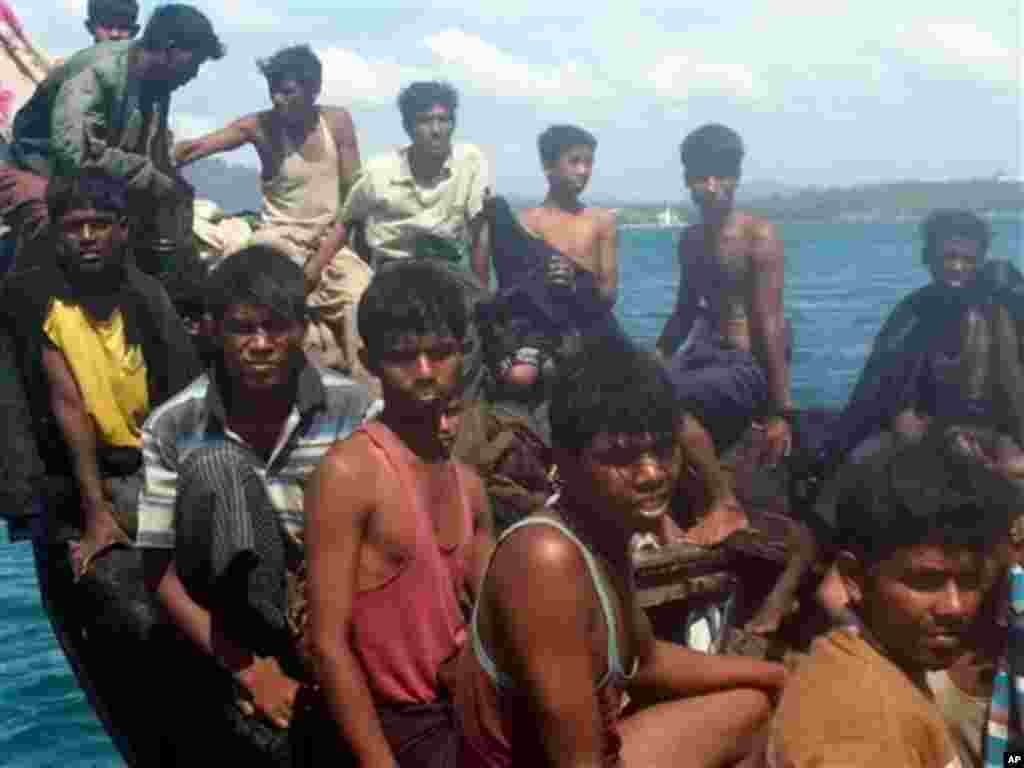 This photo taken Jan.1, 2013, Rohingya refugees sit in a boat as they are intercepted by Thai authorities off the sea in Phuket, southern Thailand. Officials said the 73 refugees from Myanmar&#39;s Rohingya minority found adrift off a Thai resort island will be repatriated to their homeland.&nbsp;