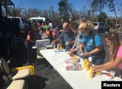 Catholic Church volunteers serve lunch to people affected by Hurricane Michael, in Callaway, Fla., Oct. 13, 2018.