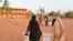 Election workers arrive with ballot boxes at the polling station during Niger's presidential election run off, in Niamey on February 21, 2021. (Photo by Issouf SANOGO / AFP)