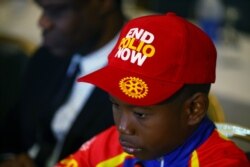 A boy wears a cap during a news conference marking the 3-year-polio-free milestone in Abuja, Nigeria, Aug. 21, 2019.