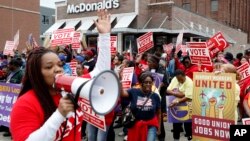 FILE - Protesters rally in front of a McDonald's restaurant, Oct. 2, 2018, in Detroit, calling for higher pay and the right to form unions in Michigan.