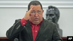 Venezuela's President Hugo Chavez salutes during the Council of Ministers at Miraflores Palace in Caracas, February 23, 2012.