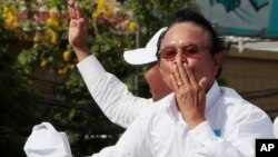 Opposition party Cambodia National Rescue Party (CNRP) President Kem Sokha greets his supporters from a truck as he leads a rally during the last day of campaigning ahead of communal elections in Phnom Penh, Cambodia, Friday, June 2, 2017. Cambodia's longtime ruler Hun Sen warned opposition parties Friday not to challenge the result of Sunday's local elections or they could be dissolved. (AP Photo/Heng Sinith)