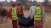 Rescue workers carry a body of a victim following a suicide attack in Maiduguri, Nigeria, April 2, 2018.