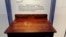 FILE - A desk is displayed in the exhibit titled "Young Jack" at the John F. Kennedy Presidential Library and Museum in Boston. An archivist at Choate, the private school in Connecticut where the president studied as a boy, insists the desk didn't belong to him.