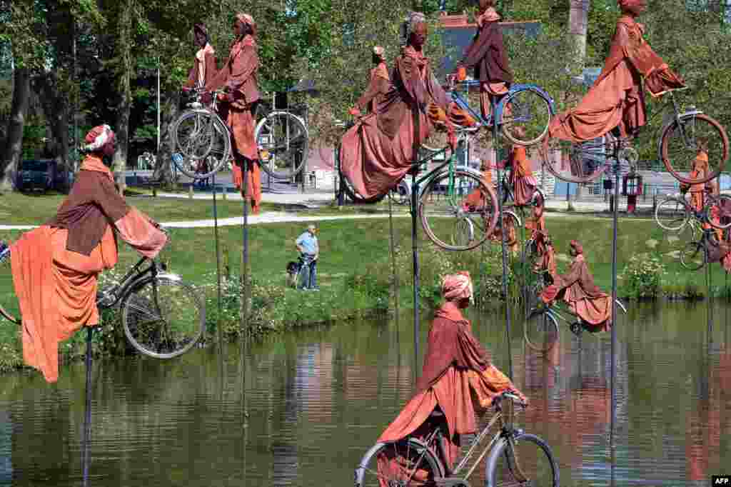 A sculpture by French artist Guy Lorgeret, entitled &quot;Retour a Betton&quot; (&quot;Return to Betton&quot;), is seen in Betton, a suburb of the western French city of Rennes. The sculpture represents people on bicycles migrating from one bank to another, claiming their freedom, like their refusal to compete.