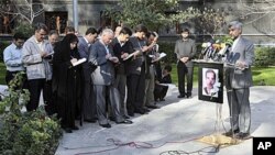 Iran's top nuclear negotiator, Saeed Jalili, right, speaks with media in Tehran, Iran, saying there will be no progress in upcoming nuclear talks with the world powers unless Iran's rights are respected, Dec 4, 2010. A picture of Majid Shahriari, a promin