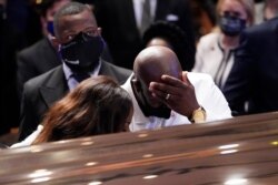 Philonise Floyd, brother, of George Floyd pauses at the casket during a funeral service for Floyd at The Fountain of Praise church, June 9, 2020, in Houston.