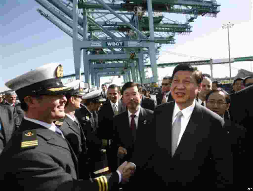 Chinese Vice President Xi Jinping , right, shakes hands with officers as he tours China Shipping at the Port Of Los Angeles in San Pedro, Calif. on Thursday, Feb. 16, 2012. (AP Photo/Los Angeles Times, Bob Chamberlin, Pool)