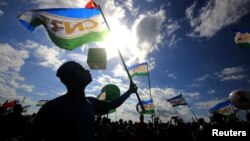 FILE - Supporters of the the National Congress for Timorese Reconstruction (CNRT) political party attend a rally ahead of this weekend's parliamentary elections in Dili, East Timor, July 18, 2017. 