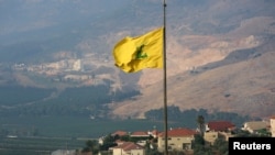 A Hezbollah flag flutters in the southern Lebanese village of Khiam, near the border with Israel, Lebanon, July 28, 2020. 