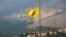 A Hezbollah flag flutters in the southern Lebanese village of Khiam, near the border with Israel, Lebanon, July 28, 2020. 