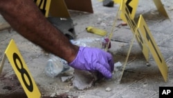 Policemen collect evidence at scene of deadly explosion in Manama, Bahrain, Nov. 5, 2012.