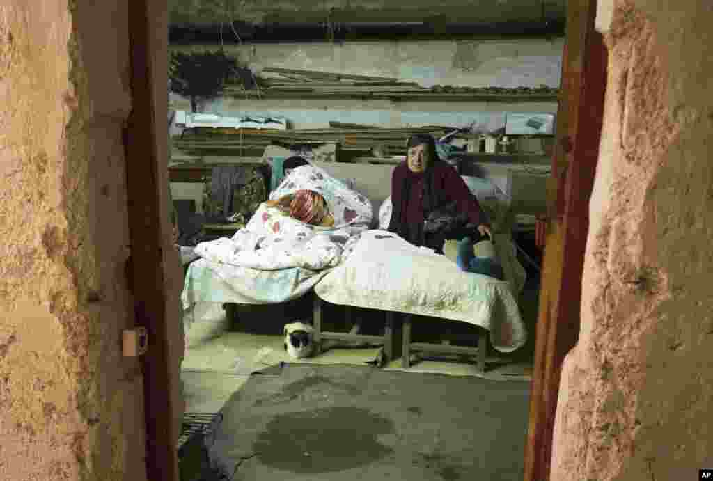 Women take refuge in a bomb shelter during a military conflict in Stepanakert, the separatist region of Nagorno-Karabakh, Friday, Oct. 16, 2020. The latest outburst of fighting between Azerbaijani and Armenian forces began Sept. 27 and marked the biggest 