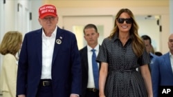 Republican presidential nominee former President Donald Trump and former first lady Melania Trump walk after voting on Election Day at the Morton and Barbara Mandel Recreation Center, in Palm Beach, Florida, Nov. 5, 2024.