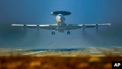 FILE - A NATO AWACS plane is seen taking off from a NATO airbase in Geilenkirchen, Germany, March 12, 2014.
