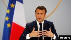 FILE - French President Emmanuel Macron responds to a question during a news conference at the Elysee Palace in Paris.