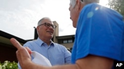 FILE - Washington Gov. Jay Inslee meets with people at the Iowa State Fair, Aug. 10, 2019, in Des Moines. Inslee announced Aug. 21 that he was ending his bid for the 2020 Democratic presidential nomination.