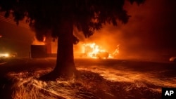 Flames consume a Kentucky Fried Chicken as the Camp Fire tears through Paradise, Calif., on Nov. 8, 2018. 