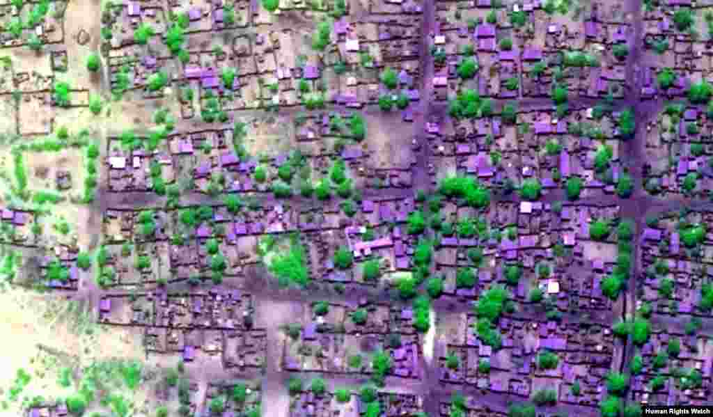 Pre-violence view of concentration of building damages, satellite imagery displayed in false-color, near-infrared to highlight areas of extensive fire-related damages and burn scars. Tantance lalatar: Kungiyar Human Rights Watch; Na’urar Tauraron Dan Adam