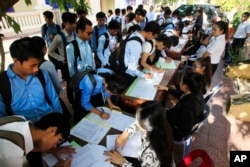 FILE - Students register to participate in a campaign by the National Election Committee, NEC, in Phnom Penh, Cambodia, Wednesday, May 9, 2018.