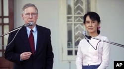 U.S. Senator Mitch McConnell (R-KY) (L) talks to reporters after meeting Burma's pro-democracy leader Aung San Suu Kyi at her home in Yangon, January 16, 2012