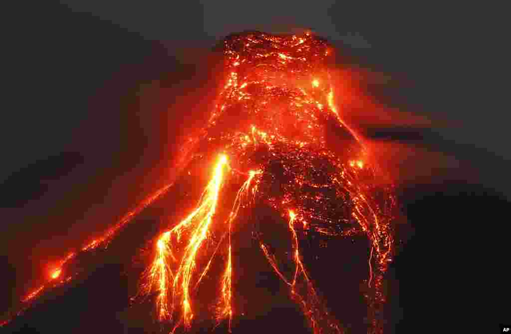 The Mayon volcano spews molten lava, Jan. 25, 2018, during its sporadic eruption in the early morning outside Legazpi city, Albay province, around 340 kilometers (200 miles) southeast of Manila, Philippines.