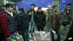 Afghans who were deported from Germany exit Kabul International Airport, Kabul, Afghanistan, Dec. 15, 2016. The chief of police at Kabul airport said the deportees - all men without families - landed around 5 a.m.