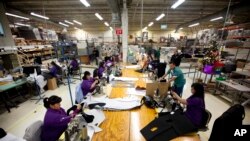 FILE - Workers manufacture car dash mats in Ciudad Juarez, Mexico, Dec. 27, 2013. U.S. President Donald Trump is examining the future of the North American Free Trade Agreement, which focused on agriculture, textiles and auto manufacturing.