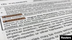 FILE - Taser warnings to police, included in Axon's training materials, are seen in this image taken from video, in Washington DC, US.