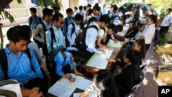 Students register to participate in a campaign by the National Election Committee, NEC, in Phnom Penh, Cambodia, Wednesday, May 9, 2018. NEC on Wednesday held its campaign with the teachers and students on the disseminate awareness of the law on the organization and functioning of the election law for the 2018 general election. (AP Photo/Heng Sinith)