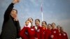 Hospitality staff members react after posing for a selfie during the opening session of China's National People's Congress (NPC) at the Great Hall of the People in Beijing, Monday, March 5, 2018. 