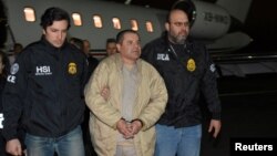 FILE - Mexico's top drug lord Joaquin "El Chapo" Guzman is escorted as he arrives at Long Island MacArthur airport in New York after his extradition from Mexico, Jan. 19, 2017.