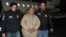 FILE - Mexico's top drug lord Joaquin "El Chapo" Guzman is escorted as he arrives at Long Island MacArthur airport in New York after his extradition from Mexico, Jan. 19, 2017.