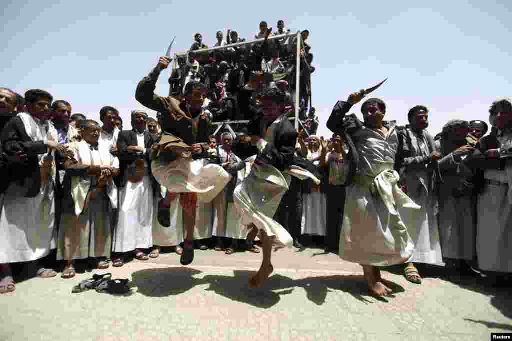 People dance the "al-Bara" during a mass wedding ceremony in Sana'a, Yemen.